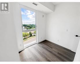 A room with a sliding glass door leading to a street.