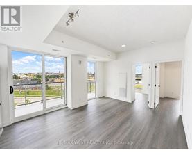 A spacious room with a view of the outdoors through large windows.