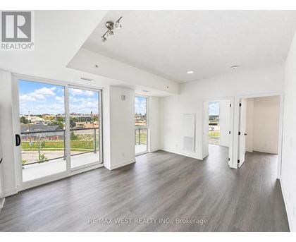 A spacious room with a view of the outdoors through large windows.