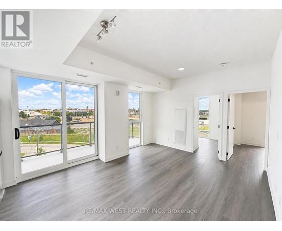 A spacious room with a view of the outdoors through large windows.