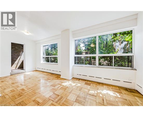 A room with a window overlooking a forest.