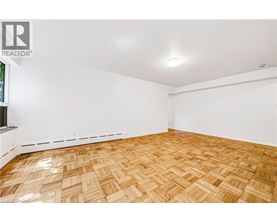A room with wooden flooring and white walls.