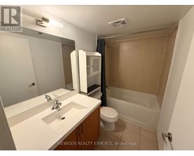 A bathroom with a sink, toilet, and bathtub.
