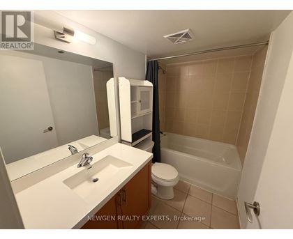 A bathroom with a sink, toilet, and bathtub.