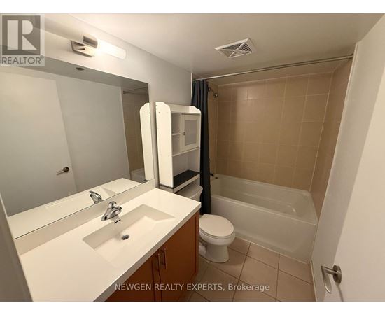 A bathroom with a sink, toilet, and bathtub.