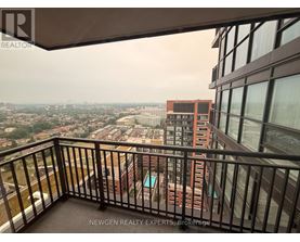 A balcony overlooks a cityscape with buildings and greenery.