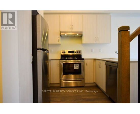 A kitchen with a stove and refrigerator.
