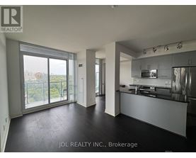 A spacious kitchen and living room with a view of the city.