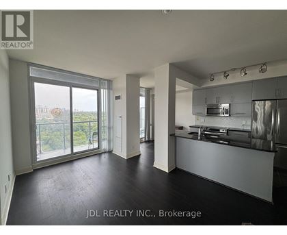 A spacious kitchen and living room with a view of the city.