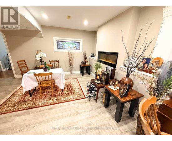 A living room with a fireplace and a dining table set up.