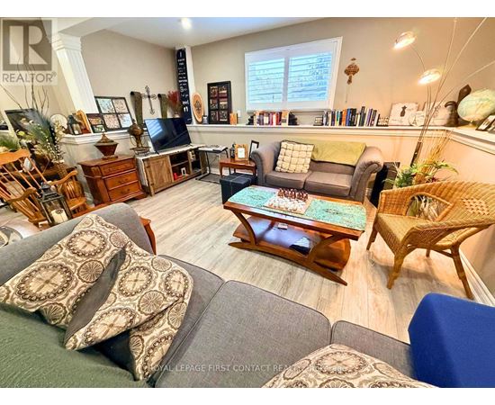 A living room with a grey couch and a wooden coffee table.