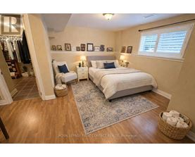 A bedroom with a large bed and a wooden floor.