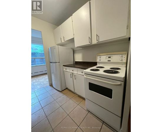 A white kitchen with a stove and cabinets.