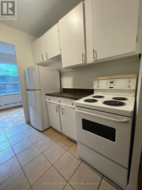 A white kitchen with a stove and cabinets.