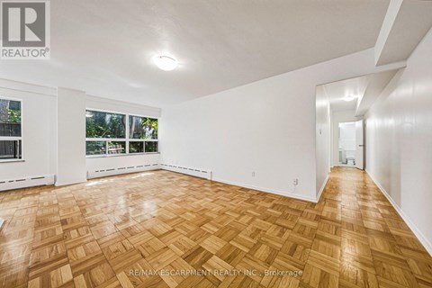 A kitchen with white cabinets and a tiled floor.