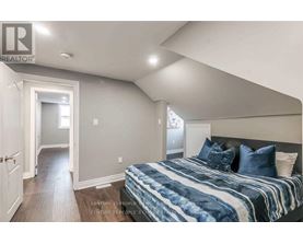 A bedroom with a bed and a window.
