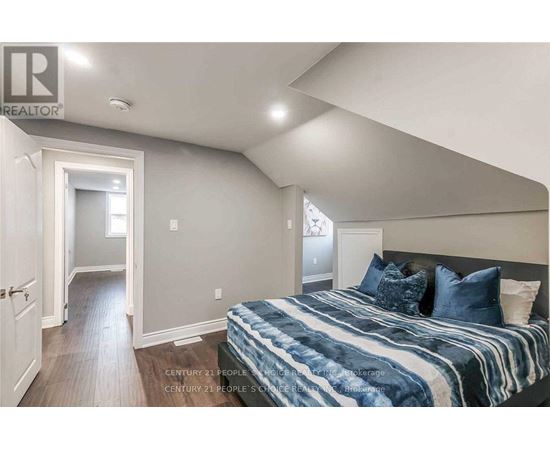 A bedroom with a bed and a window.