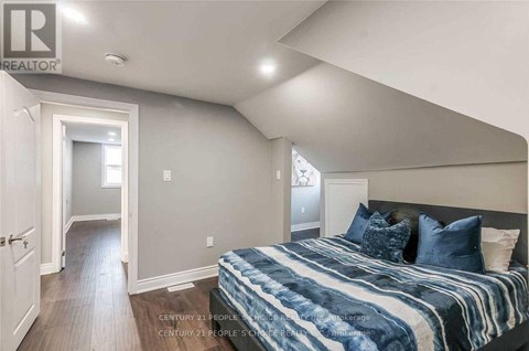 A bedroom with a bed and a window.