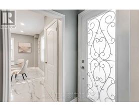 A white door with a decorative design on the right side.