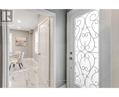 A white door with a decorative design on the right side.