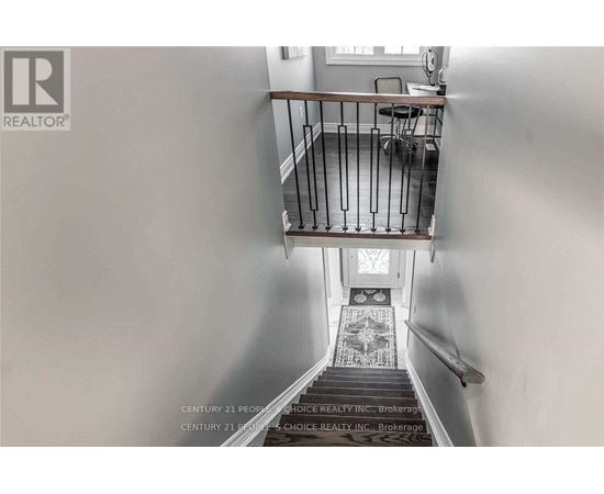 A staircase with a metal railing and a tiled floor.