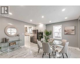 A modern dining room with a glass table and chairs.