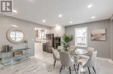 A modern dining room with a glass table and chairs.