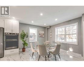 A modern kitchen with a dining table set for four.