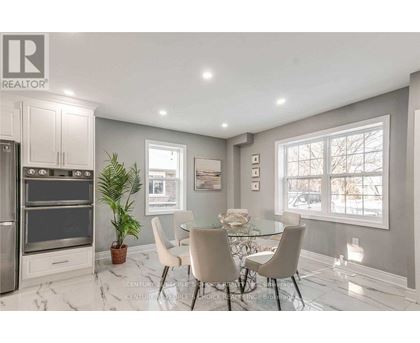 A modern kitchen with a dining table set for four.