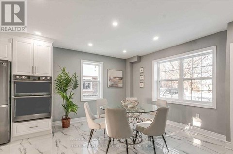 A modern kitchen with a dining table set for four.