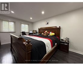 A bedroom with a large bed and a teddy bear on it.
