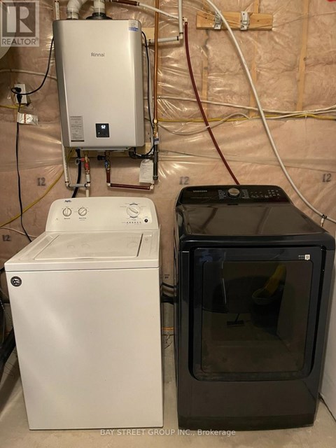 A washer and dryer are sitting next to each other in a laundry room.