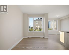 A white room with a window showing a view of a building across the street.