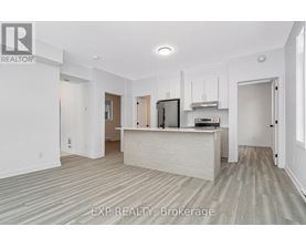 A realtor brokerage office with a white reception desk and a television on the wall.