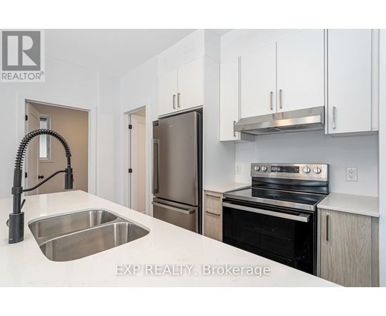 A kitchen with white cabinets and stainless steel appliances.