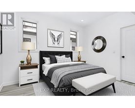 A bedroom with a large bed, a bench, and a mirror on the wall.