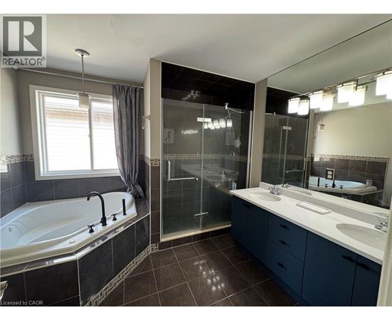 A bathroom with a tub, sink, and mirror.