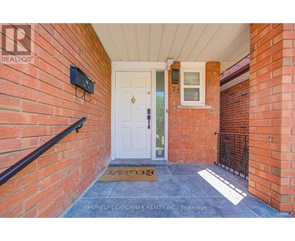 A white door is on the left side of a brick wall.