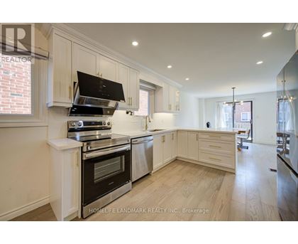 A modern kitchen with a stove top oven and a range hood.
