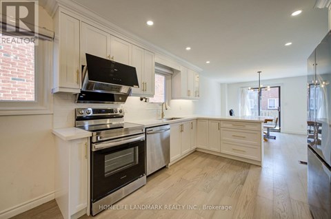 A modern kitchen with a stove top oven and a range hood.
