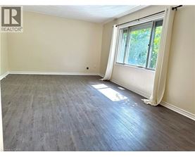 A room with a window and wooden flooring.
