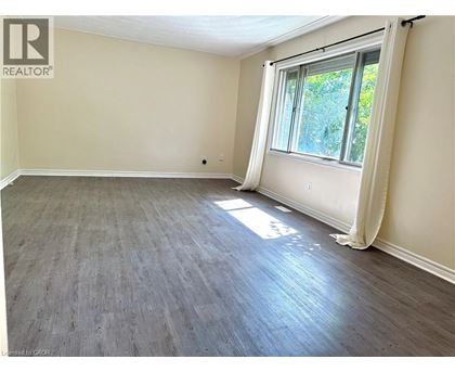 A room with a window and wooden flooring.