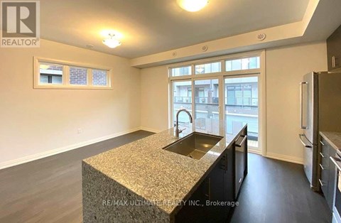 A kitchen with granite countertops and stainless steel appliances.
