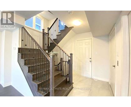 A staircase with a black railing and wooden steps.