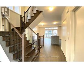 A staircase with a metal railing and wooden steps.