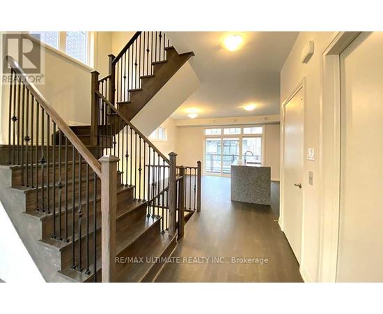 A staircase with a metal railing and wooden steps.