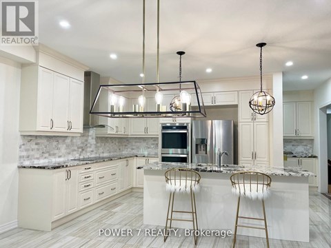 A modern kitchen with a marble countertop and a large island.