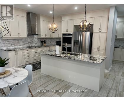 A modern kitchen with granite countertops and stainless steel appliances.