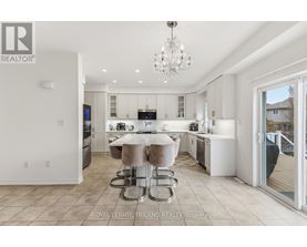 A modern kitchen with a dining table and chairs.