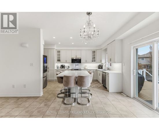 A modern kitchen with a dining table and chairs.